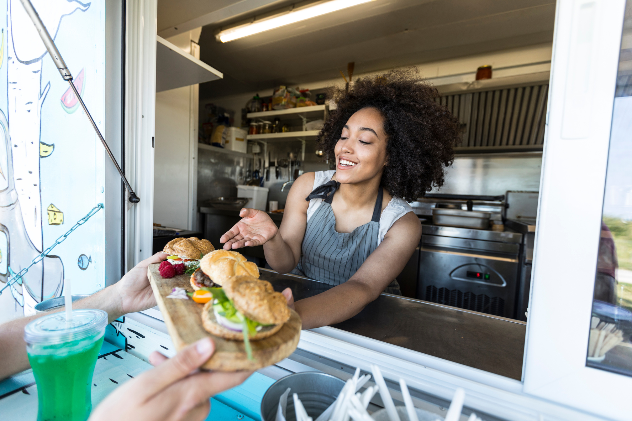 Customer taking burgers from food truck